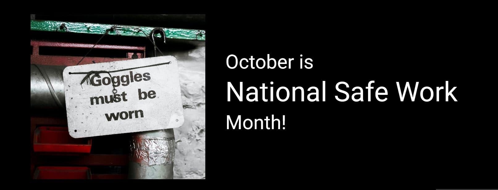 A sign reading "Goggles must be worn" hangs on metal pipes. The text "October is National Safe Work Month!" appears to the right on a black background, emphasizing the importance of maintaining a safe work environment.
